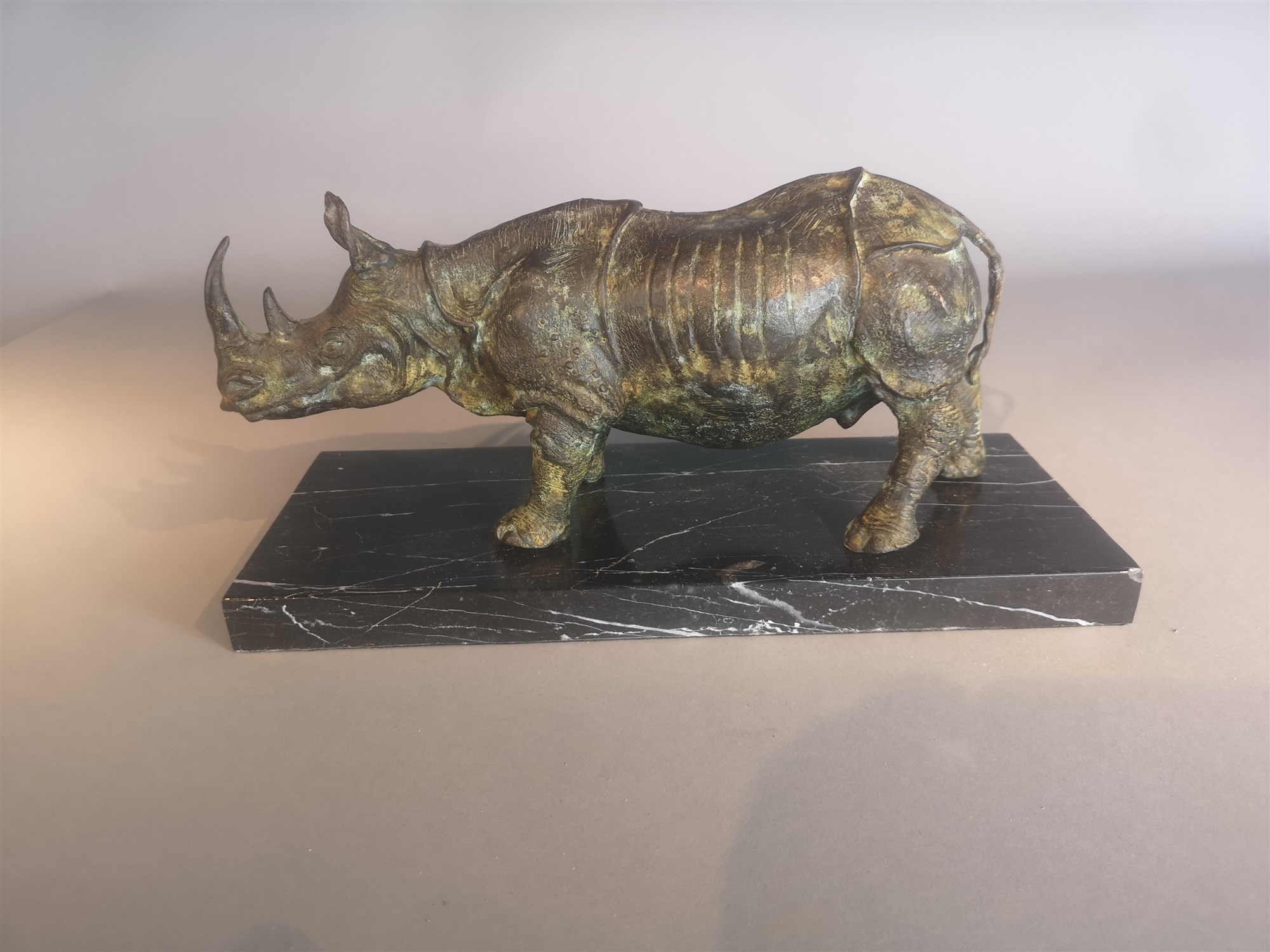 Lot 12 - Sculpture: A bronze rhinoceros modern on